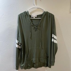 Darker green with white stripes on sleeve.